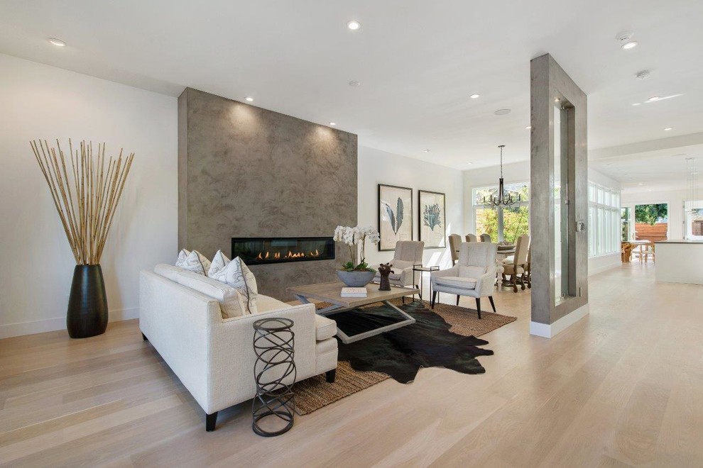 Large transitional formal open concept living room in San Francisco with white walls, light hardwood floors, a ribbon fireplace, a concrete fireplace surround, no tv and beige floor.