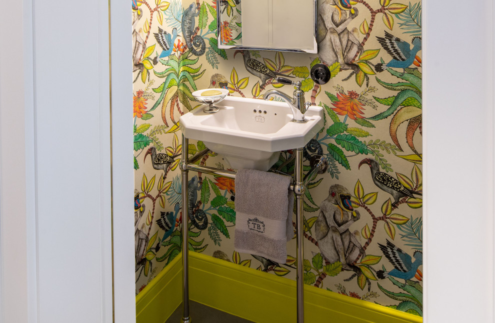 Photo of a medium sized classic cloakroom in Other with multi-coloured walls, a console sink, a freestanding vanity unit and wallpapered walls.