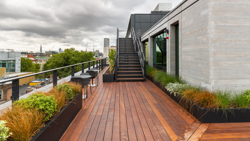 This is an example of a large contemporary roof rooftop mixed railing terrace in London with a potted garden and no cover.