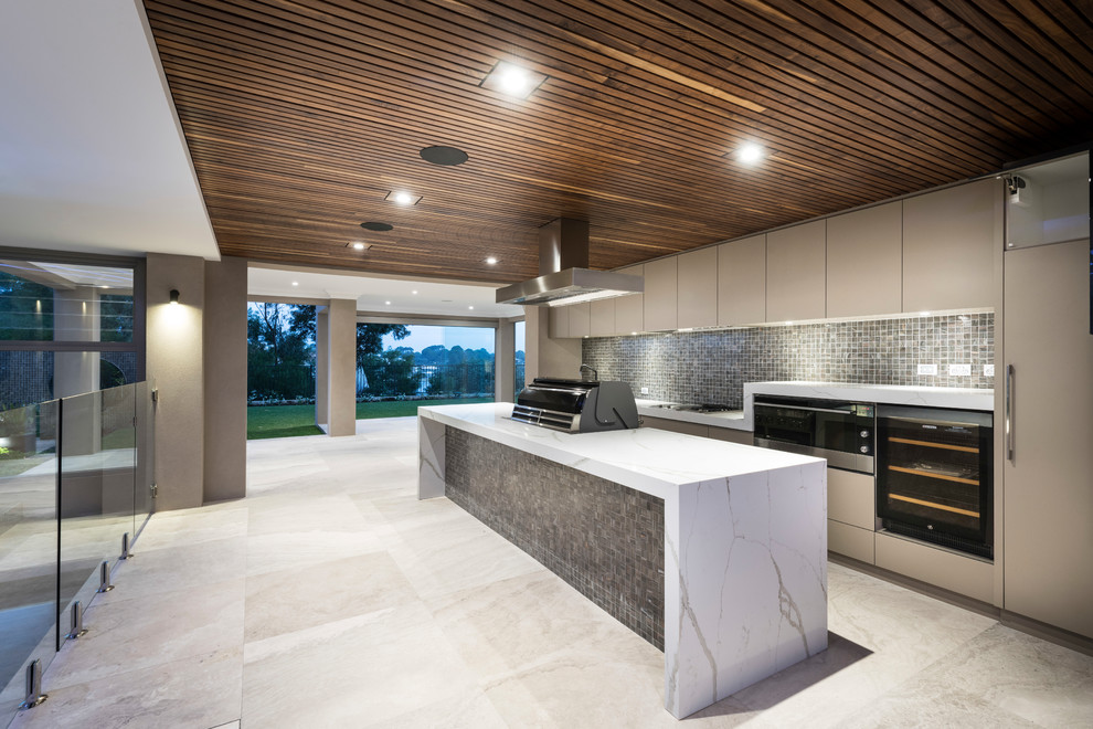 This is an example of a mid-sized contemporary galley open plan kitchen in Perth with an undermount sink, grey cabinets, quartz benchtops, brown splashback, mosaic tile splashback, stainless steel appliances, medium hardwood floors, with island and brown floor.