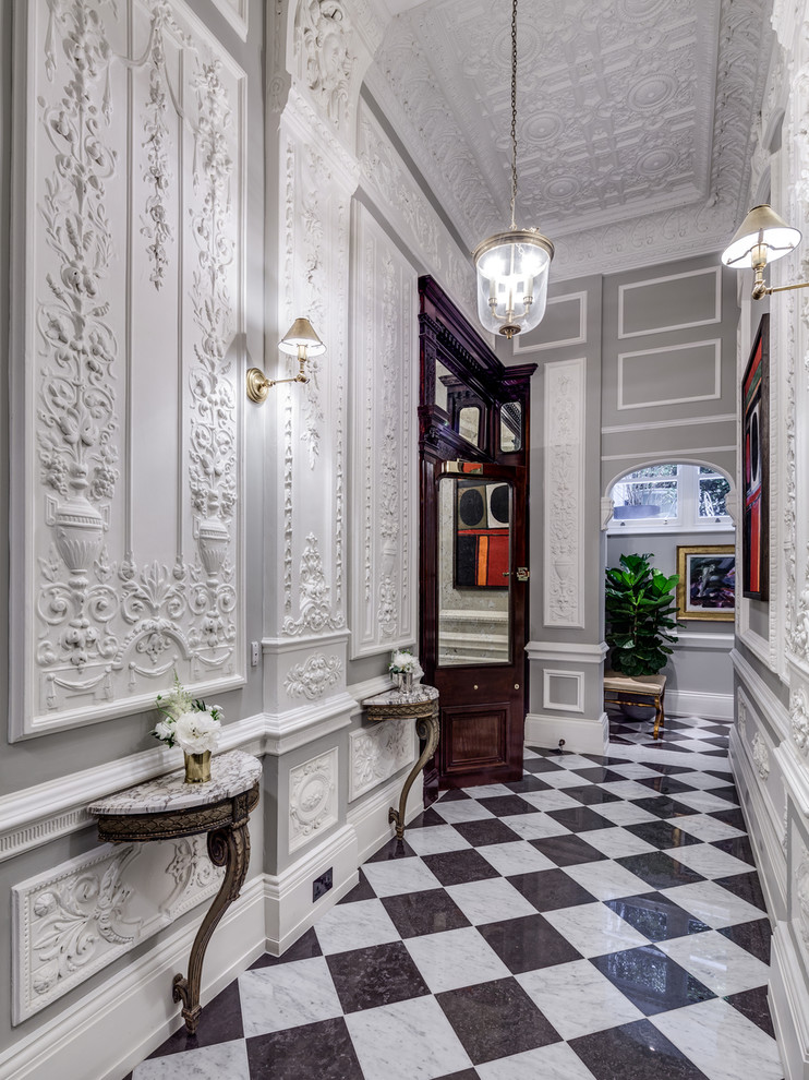 Traditional hallway in London with grey walls and marble floors.