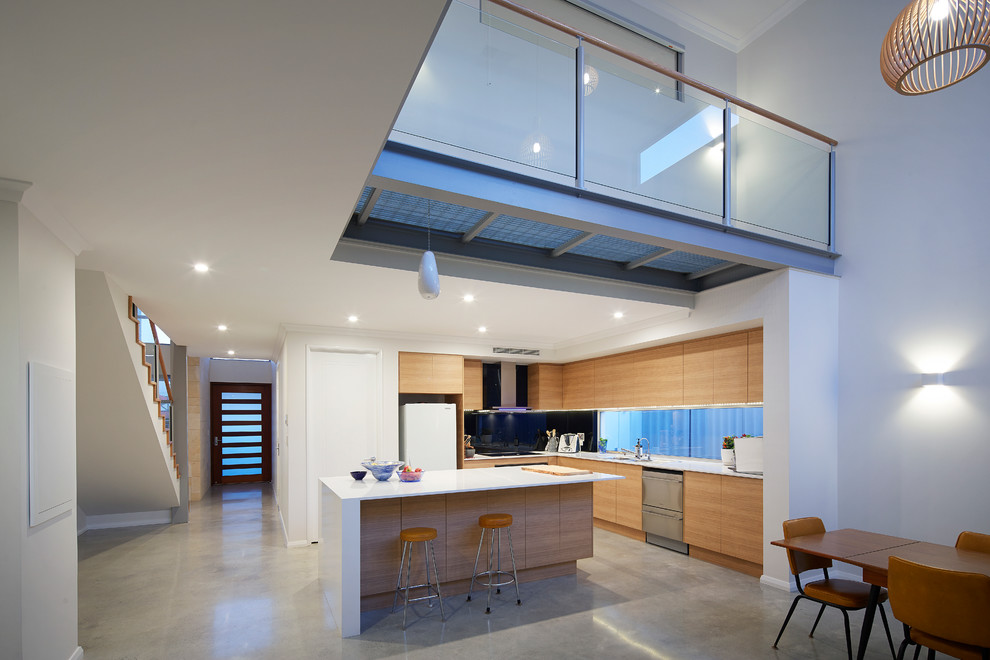 Design ideas for a mid-sized contemporary l-shaped open plan kitchen in Perth with a double-bowl sink, medium wood cabinets, quartz benchtops, black splashback, glass sheet splashback, stainless steel appliances, concrete floors and with island.