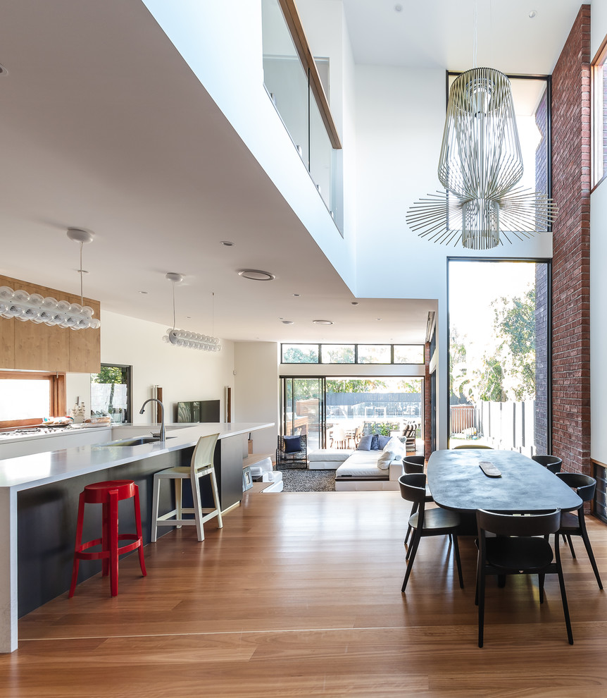 Inspiration for a contemporary open plan kitchen in Brisbane with flat-panel cabinets, medium wood cabinets, medium hardwood floors, with island and brown floor.