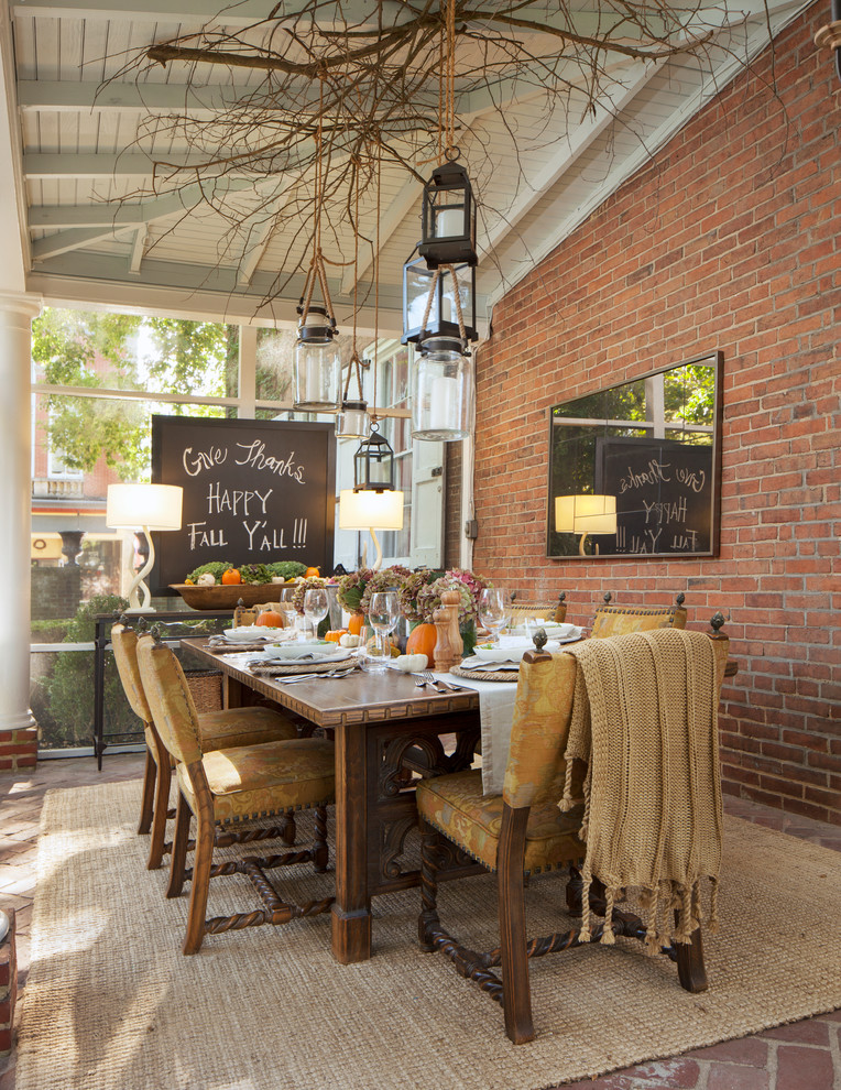 Photo of a country dining room in Philadelphia with brick floors.