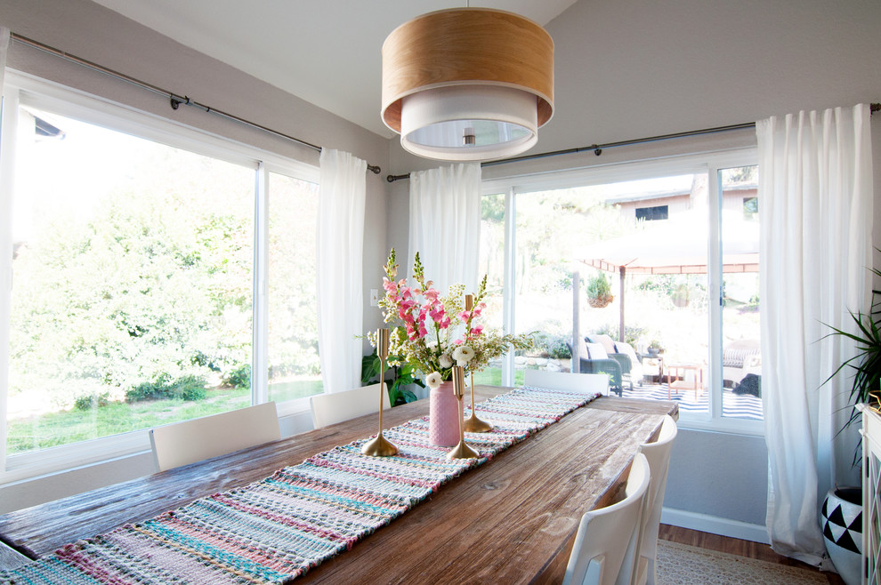 This is an example of a small eclectic open plan dining in Los Angeles with grey walls.