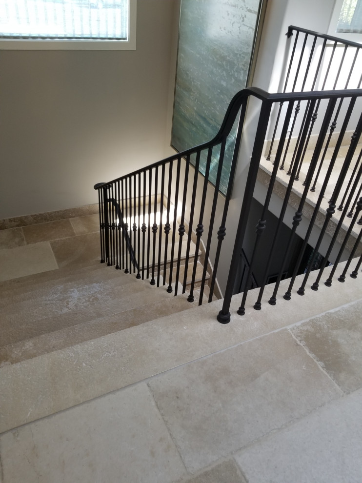 Design ideas for a large modern concrete u-shaped staircase in Los Angeles with concrete risers and metal railing.