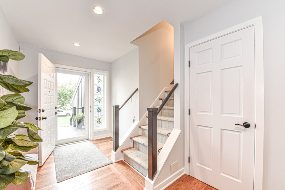 Kleine Retro Haustür mit grauer Wandfarbe, braunem Holzboden, Einzeltür und weißer Haustür in New York