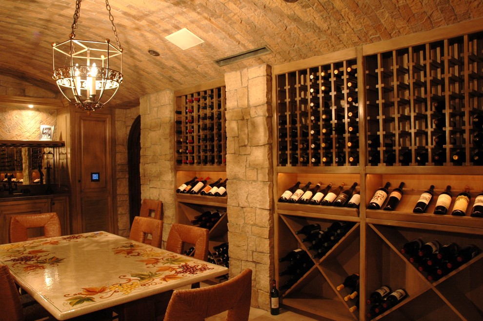 Photo of a large country wine cellar with ceramic floors and storage racks.