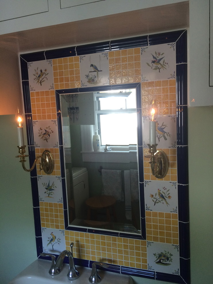 Small traditional powder room in Manchester with mosaic tile.