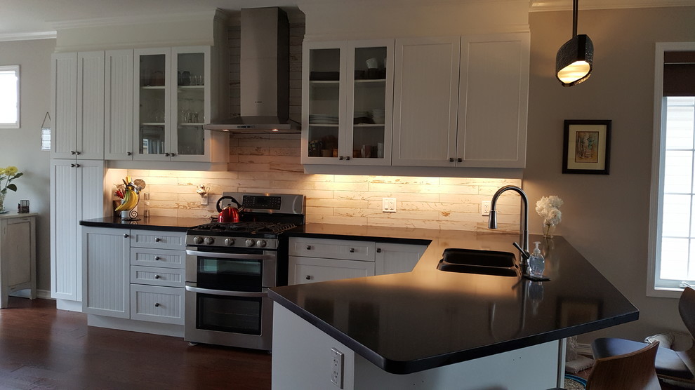 Open concept kitchen - mid-sized rustic l-shaped medium tone wood floor and brown floor open concept kitchen idea with an undermount sink, white cabinets, quartz countertops, multicolored backsplash, porcelain backsplash, stainless steel appliances, a peninsula and shaker cabinets