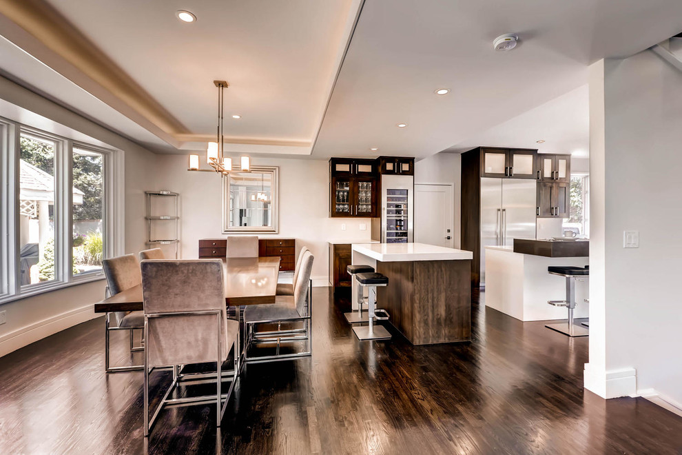 Example of a large transitional l-shaped dark wood floor eat-in kitchen design in Denver with an undermount sink, shaker cabinets, dark wood cabinets, quartz countertops, stainless steel appliances and two islands