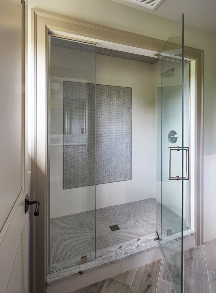 Inspiration for a large traditional master bathroom in Other with raised-panel cabinets, dark wood cabinets, a drop-in tub, an open shower, a one-piece toilet, beige tile, mosaic tile, beige walls, ceramic floors, a drop-in sink, soapstone benchtops and a hinged shower door.