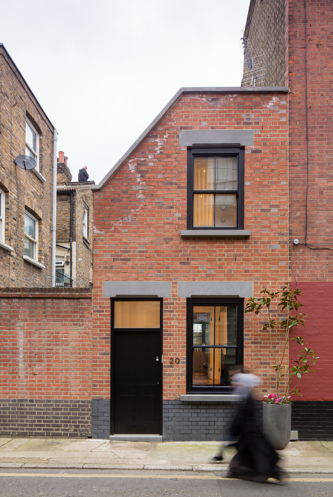 Industrial two-storey brick townhouse exterior in London.