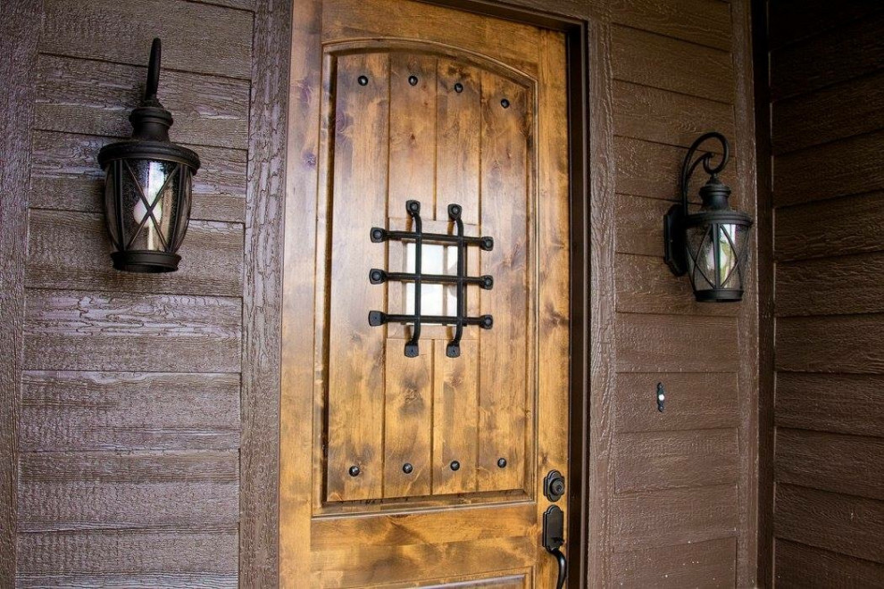 Concrete floor single front door photo in Dallas with brown walls and a dark wood front door