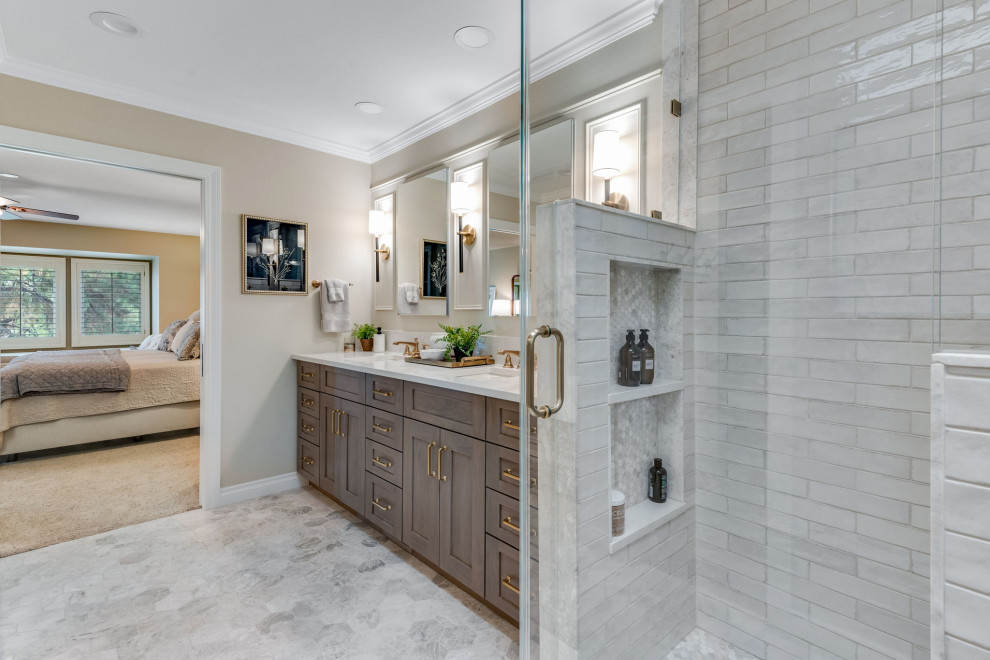 Example of a mid-sized classic master white tile and subway tile marble floor, white floor, double-sink and wall paneling alcove shower design in Denver with recessed-panel cabinets, brown cabinets, a one-piece toilet, beige walls, an undermount sink, quartz countertops, a hinged shower door, white countertops, a niche and a built-in vanity