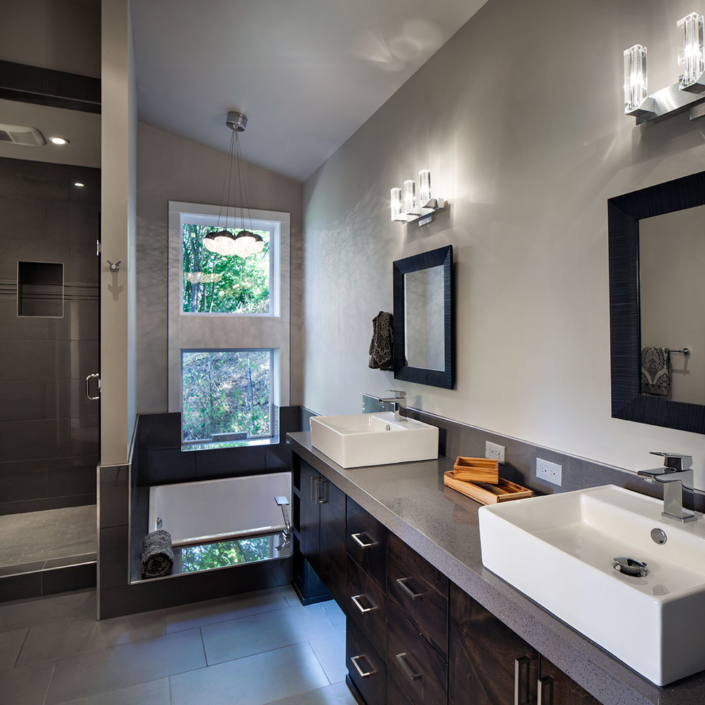 Design ideas for a large contemporary master bathroom in Portland with a vessel sink, flat-panel cabinets, dark wood cabinets, engineered quartz benchtops, a drop-in tub, an alcove shower, a two-piece toilet, gray tile, porcelain tile, grey walls and porcelain floors.