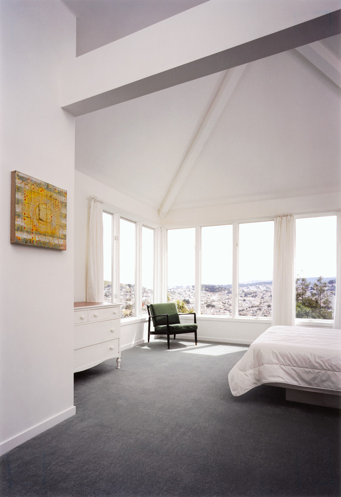 This is an example of a contemporary bedroom in San Francisco with white walls and carpet.