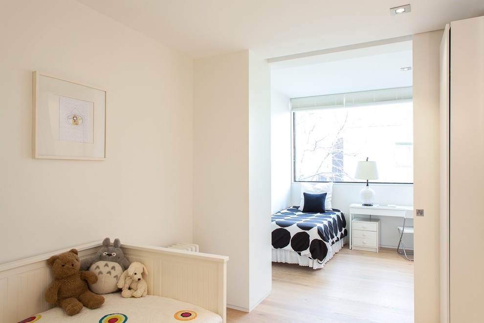 This is an example of a contemporary kids' bedroom in Toronto with white walls.