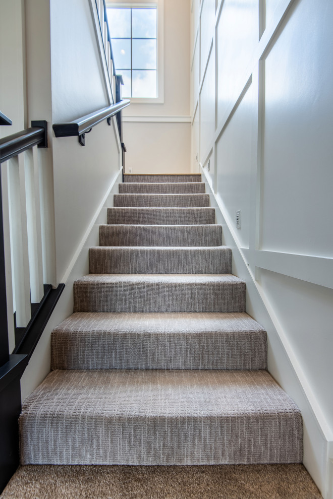 Design ideas for a mid-sized transitional carpeted straight staircase in Other with carpet risers and wood railing.