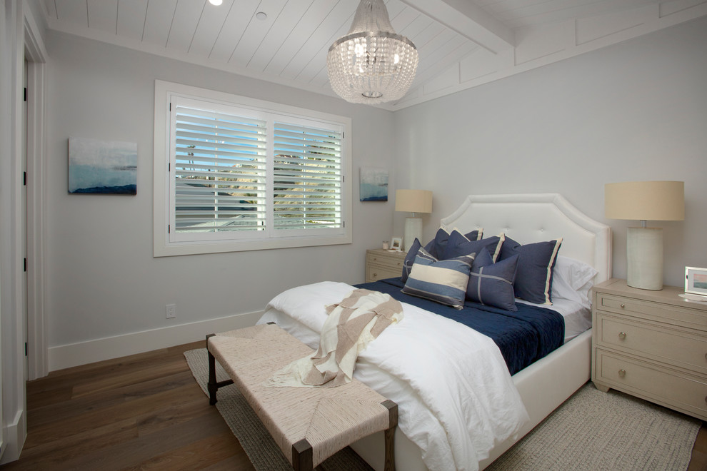 Inspiration for a beach style bedroom in Orange County with grey walls, dark hardwood floors and no fireplace.