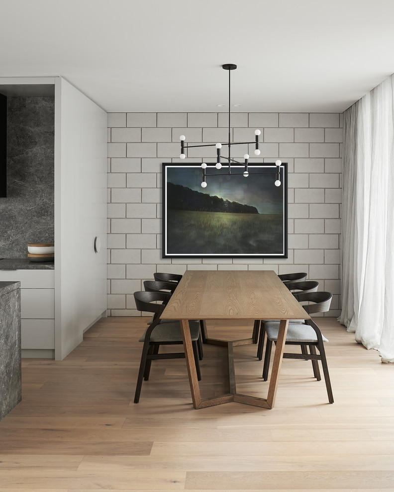 Photo of a modern kitchen/dining combo in Melbourne with light hardwood floors, no fireplace, grey walls and beige floor.