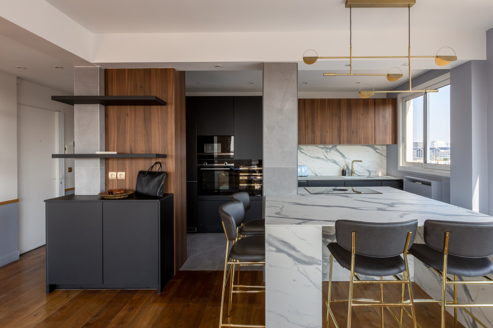 Design ideas for a large contemporary single-wall open plan kitchen in Paris with a submerged sink, beaded cabinets, black cabinets, laminate countertops, white splashback, ceramic splashback, black appliances, ceramic flooring, an island, grey floors and white worktops.