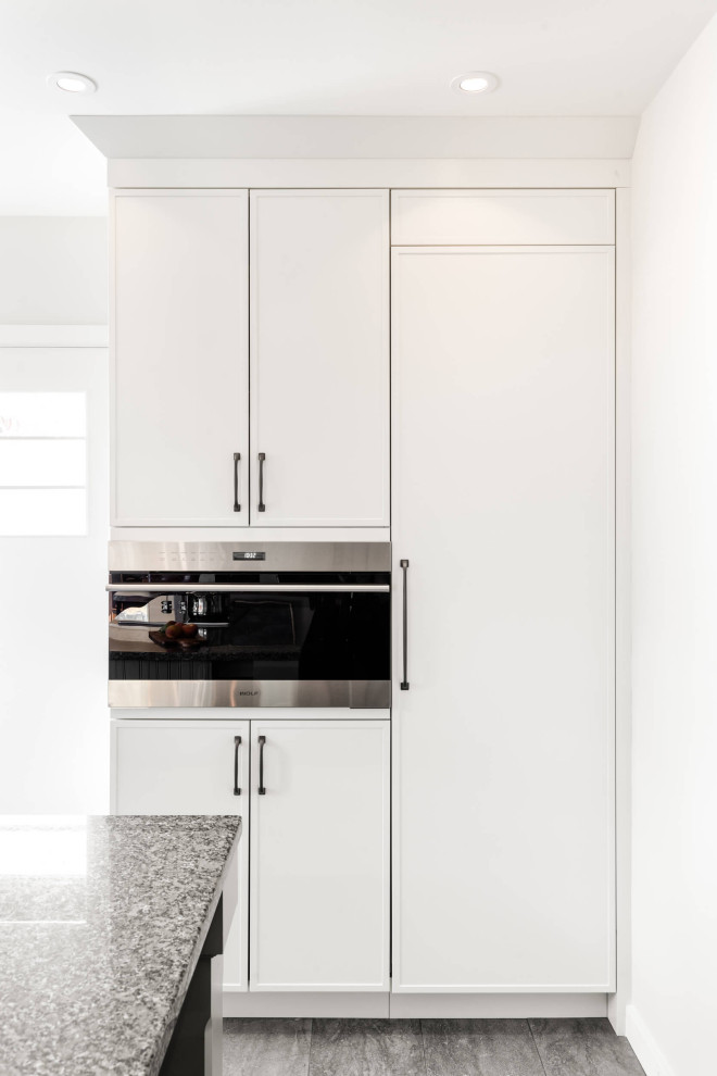 Mid-sized transitional galley eat-in kitchen photo with shaker cabinets and an island