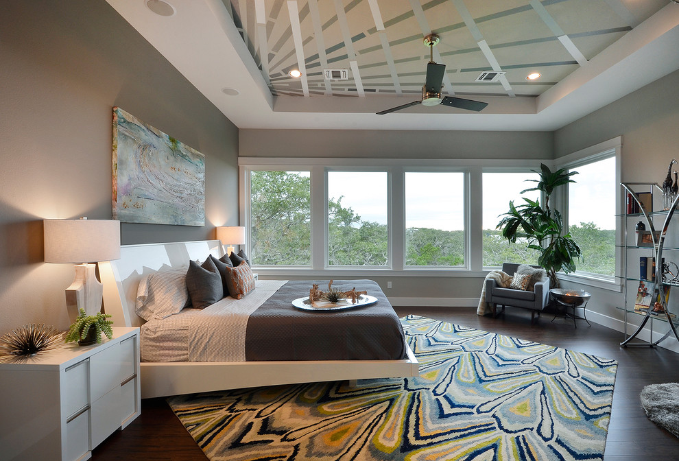 This is an example of a contemporary bedroom in Austin with grey walls.