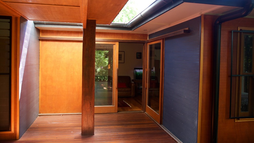Mid-sized tropical two-storey blue exterior in Brisbane with concrete fiberboard siding.