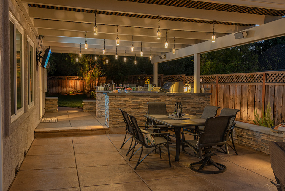 Inspiration for a large contemporary backyard patio in San Francisco with an outdoor kitchen, stamped concrete and a pergola.