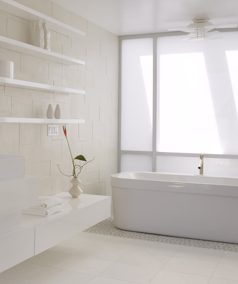 Modern bathroom in San Francisco with a freestanding tub and pebble tile floors.