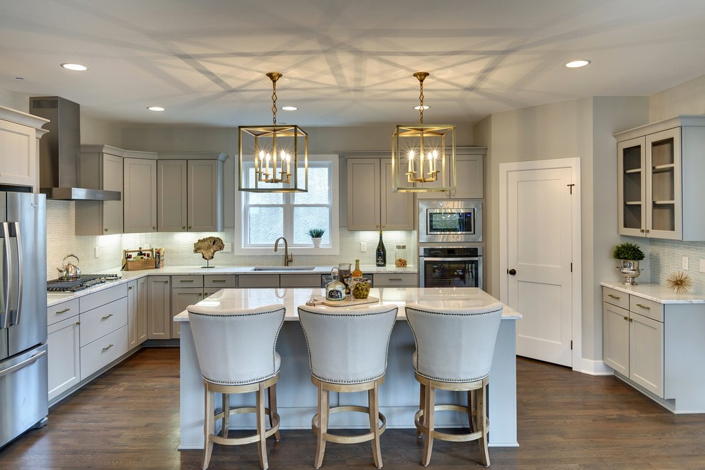Inspiration for a transitional u-shaped kitchen in Minneapolis with shaker cabinets, grey cabinets, blue splashback, stainless steel appliances, medium hardwood floors and with island.