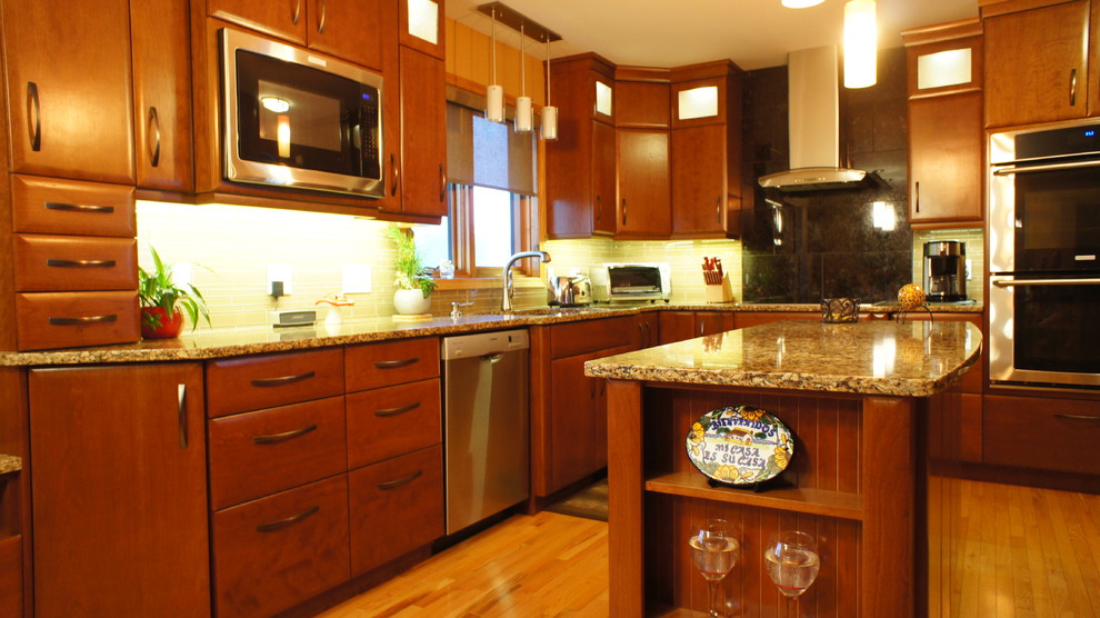 Inspiration for a large transitional u-shaped medium tone wood floor and beige floor open concept kitchen remodel with an undermount sink, flat-panel cabinets, dark wood cabinets, granite countertops, gray backsplash, subway tile backsplash, stainless steel appliances and an island