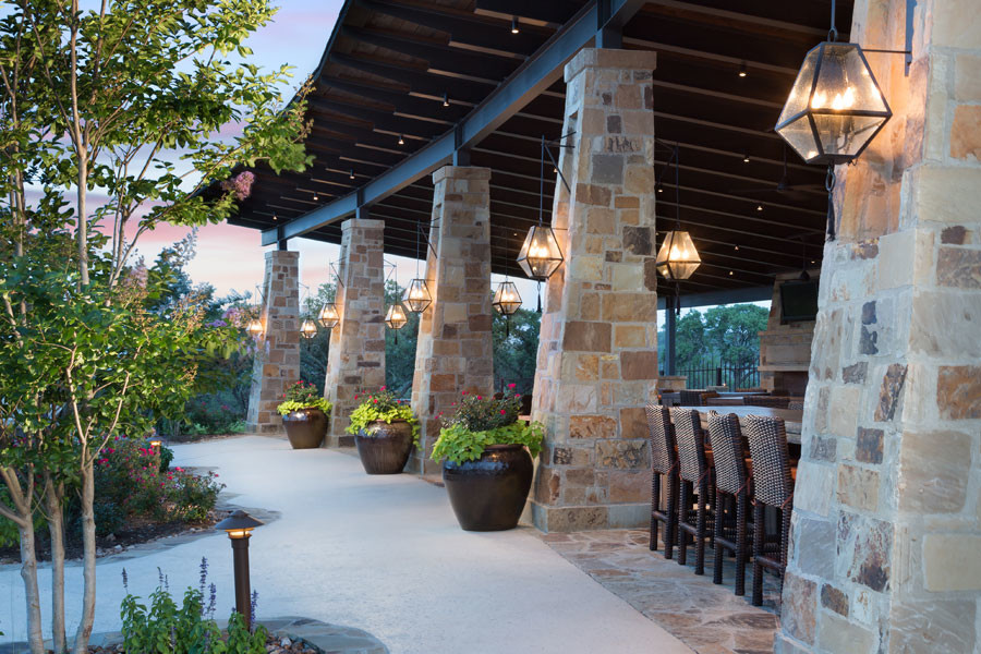 Inspiration for an expansive arts and crafts backyard patio in Austin with natural stone pavers and a gazebo/cabana.