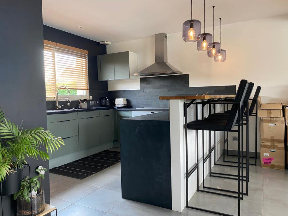 Design ideas for a mid-sized modern u-shaped eat-in kitchen in Other with an undermount sink, beaded inset cabinets, green cabinets, concrete benchtops, black splashback, stone slab splashback, stainless steel appliances, no island, grey floor and black benchtop.