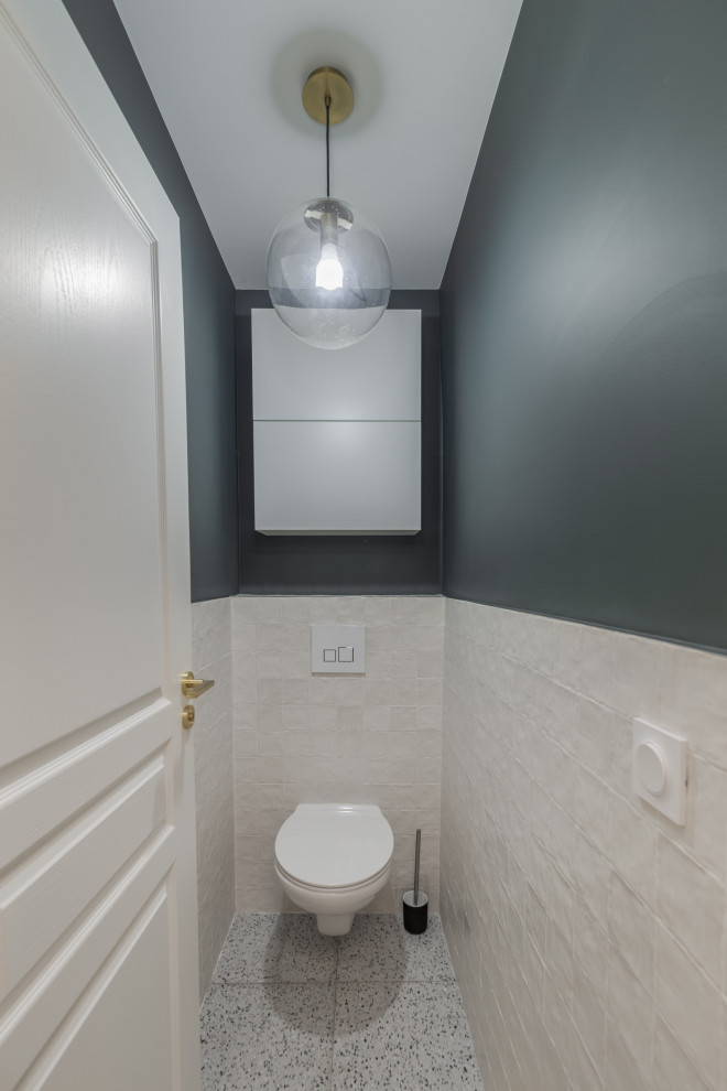 Aménagement d'un WC suspendu contemporain de taille moyenne avec des portes de placard blanches, un carrelage blanc, mosaïque, un mur vert, un sol en terrazzo, un sol gris et meuble-lavabo suspendu.