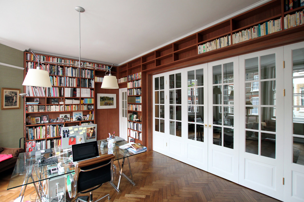 Inspiration for an expansive midcentury study room in London with medium hardwood floors, a freestanding desk and brown walls.