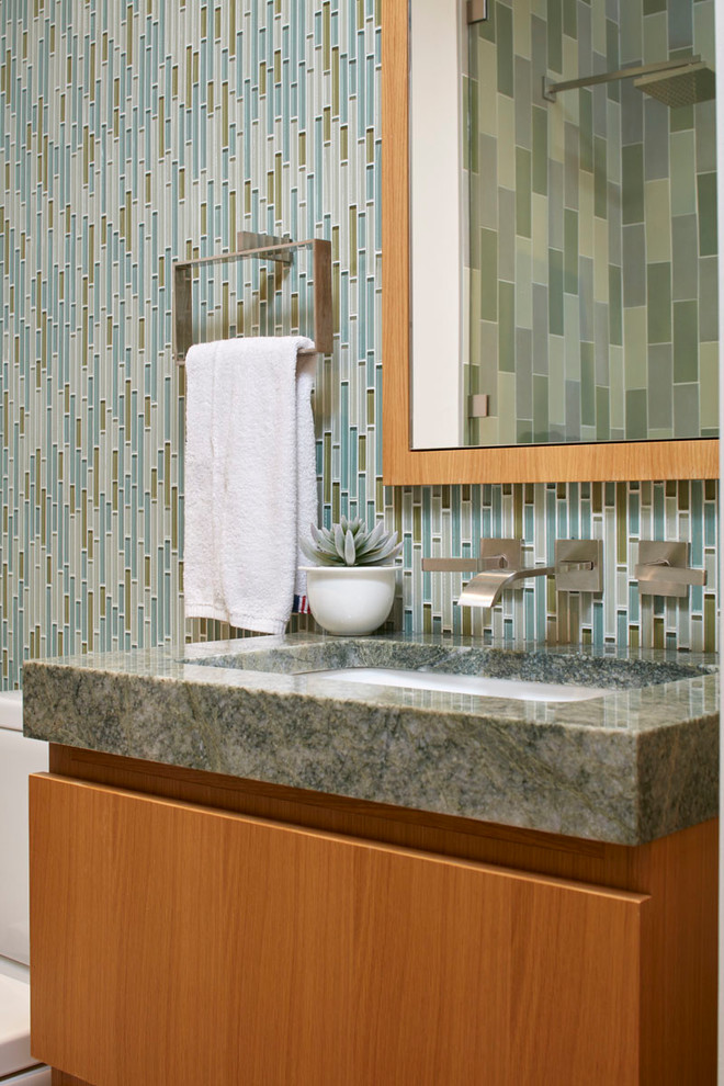 Small contemporary 3/4 bathroom in New York with flat-panel cabinets, brown cabinets, an alcove shower, a two-piece toilet, blue tile, matchstick tile, white walls, an undermount sink, granite benchtops, a hinged shower door and green benchtops.