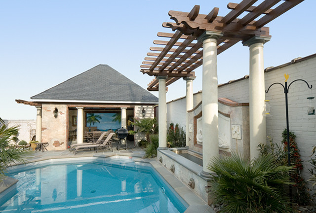 Mid-sized mediterranean backyard custom-shaped pool in Other with a water feature.