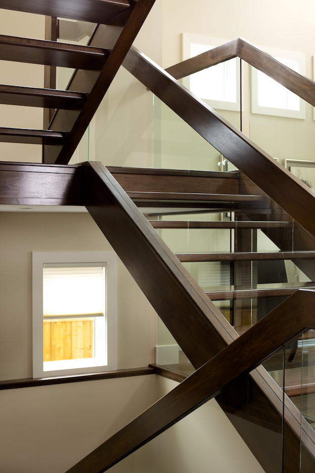Straight maple stair with glass panel railing ...