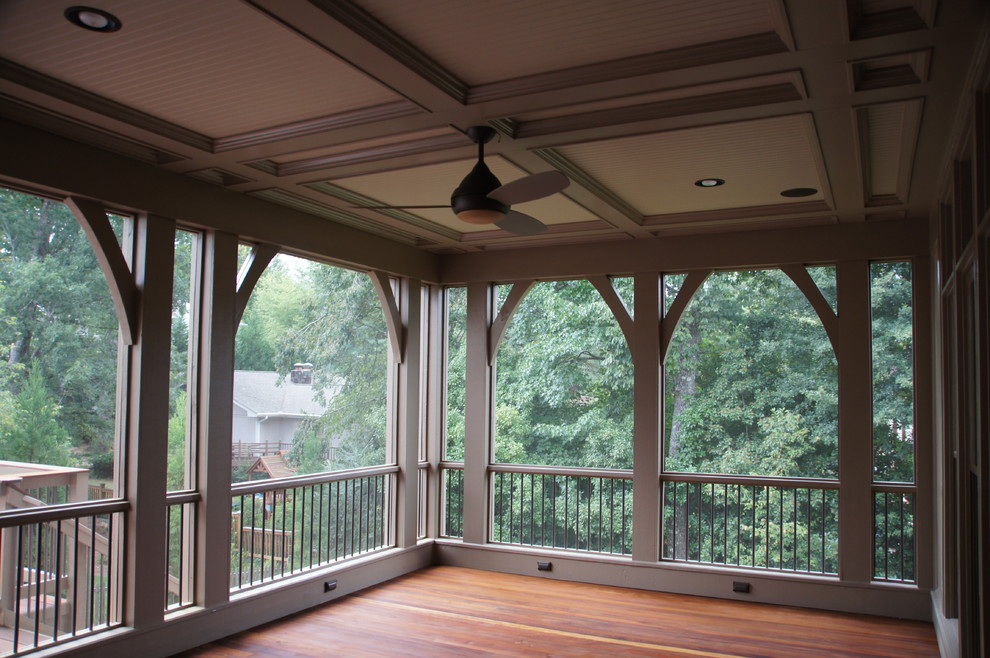 This is an example of a mid-sized transitional backyard verandah in Atlanta with a roof extension.