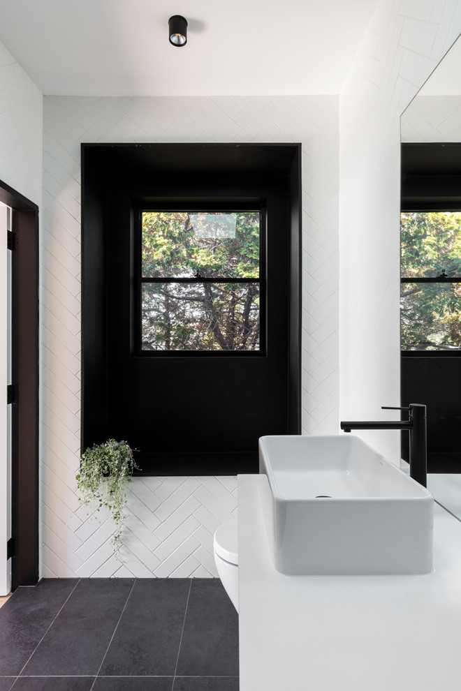 Design ideas for a mid-sized contemporary 3/4 bathroom in Sydney with flat-panel cabinets, white cabinets, an open shower, a wall-mount toilet, white tile, ceramic tile, white walls, ceramic floors, a vessel sink, engineered quartz benchtops, grey floor and an open shower.