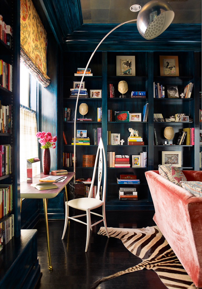 Inspiration for an eclectic home office in San Francisco with a library and black floor.