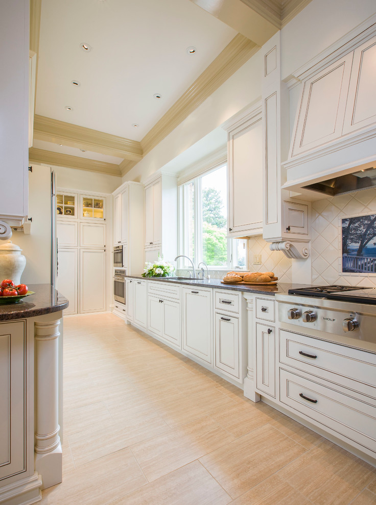 Design ideas for a large country galley separate kitchen in Detroit with an undermount sink, recessed-panel cabinets, white cabinets, granite benchtops, white splashback, stainless steel appliances, light hardwood floors, ceramic splashback, a peninsula and beige floor.