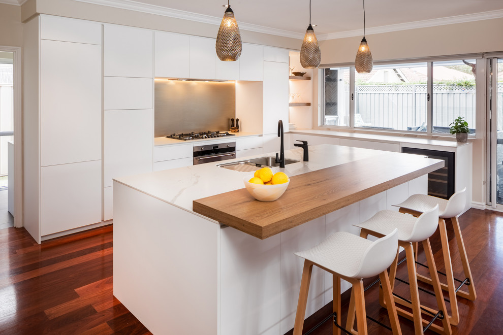 Mid-sized modern l-shaped open plan kitchen in Perth with medium hardwood floors and with island.
