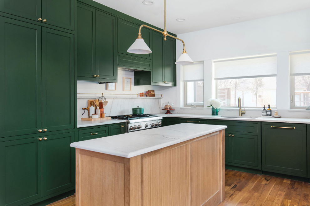 Mid-sized transitional u-shaped medium tone wood floor and brown floor open concept kitchen photo in Austin with an undermount sink, shaker cabinets, green cabinets, quartzite countertops, white backsplash, stone slab backsplash, stainless steel appliances, an island and white countertops