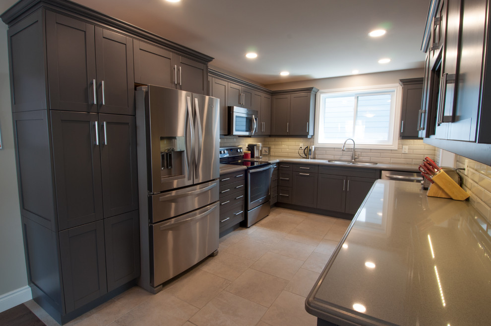 Mid-sized transitional u-shaped ceramic tile and beige floor enclosed kitchen photo in Toronto with a double-bowl sink, shaker cabinets, dark wood cabinets, quartzite countertops, beige backsplash, subway tile backsplash, stainless steel appliances and no island