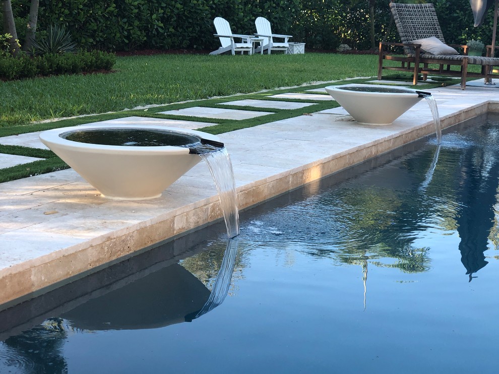 Pool - large contemporary backyard tile and rectangular lap pool idea in Miami