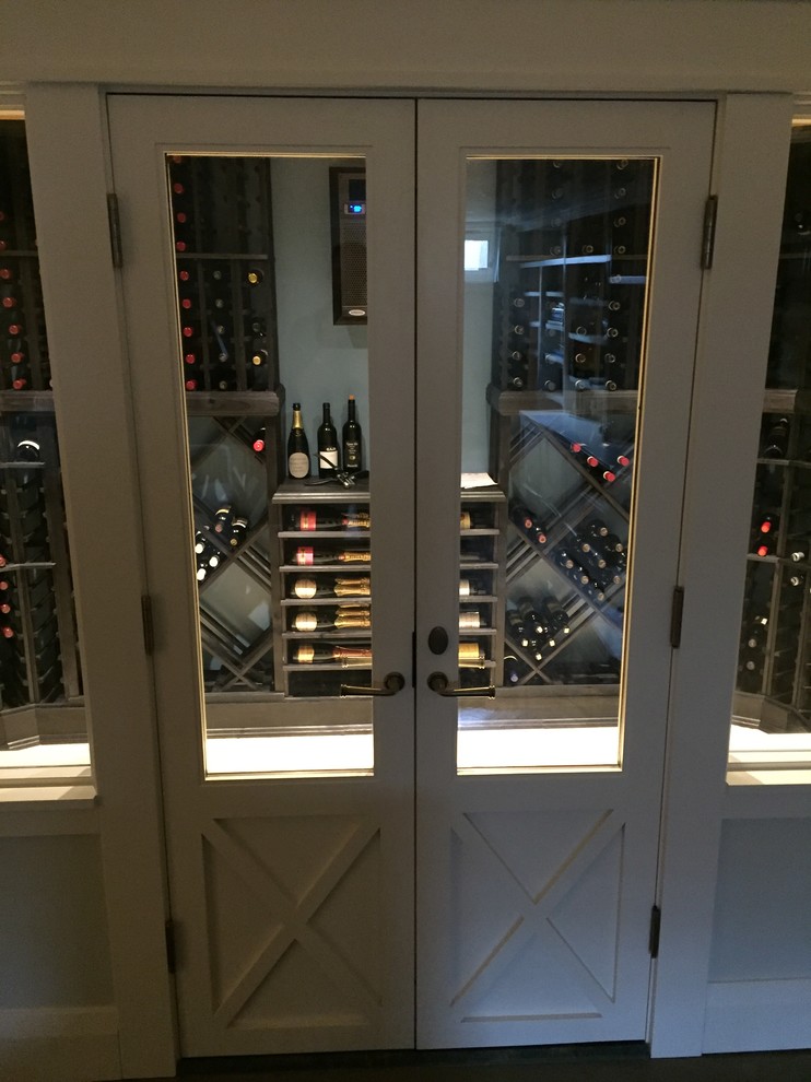 This is an example of a mid-sized traditional wine cellar in Seattle with porcelain floors and storage racks.