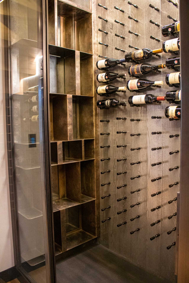Design ideas for a small arts and crafts wine cellar in Other with painted wood floors and storage racks.